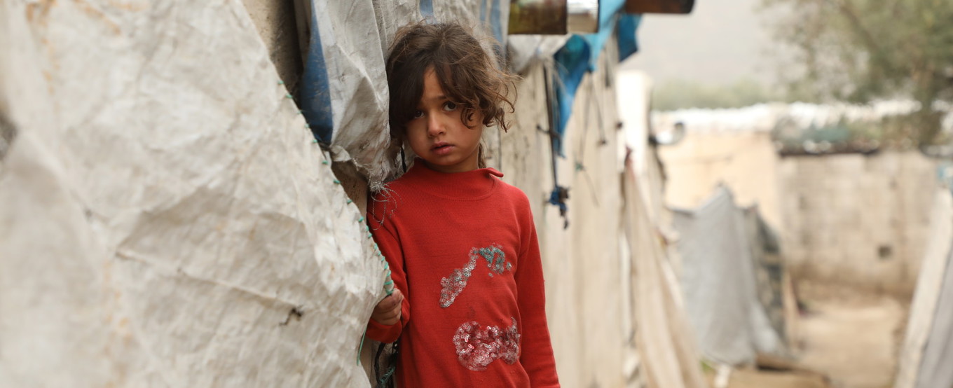 Child clutching a tent